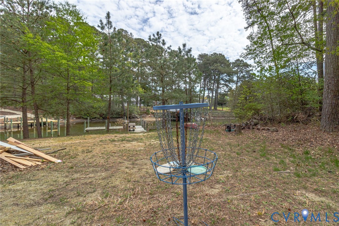 193 Deep Water Lane Reedville, VA 22539 - Photo 75 of 84 a backyard of a house with table and chairs