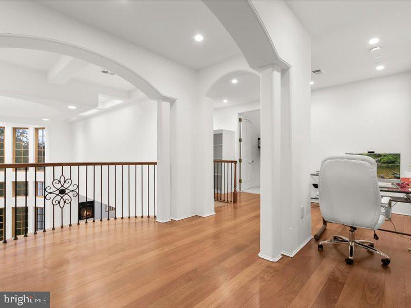 10130 Counselman Road Potomac, MD 20854 - Photo 112 of 135 a view of a hallway with wooden floor and a living room