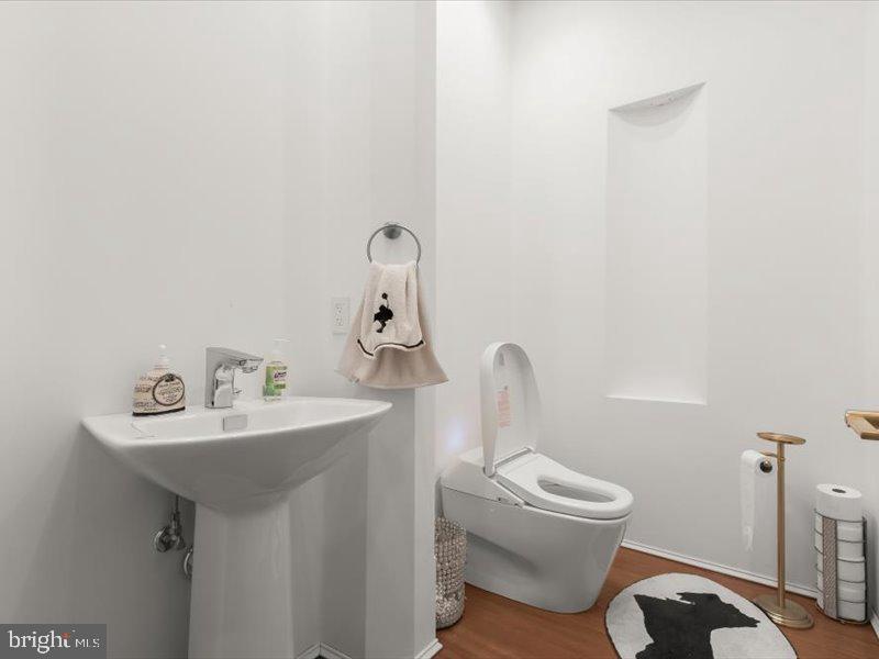 10130 Counselman Road Potomac, MD 20854 - Photo 130 of 135 a bathroom with a toilet sink and mirror