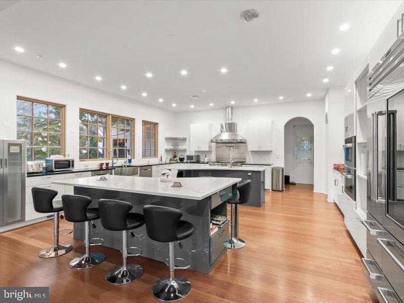 10130 Counselman Road Potomac, MD 20854 - Photo 24 of 135 a open dining hall with stainless steel appliances granite countertop a stove and refrigerator a sink with wooden floor