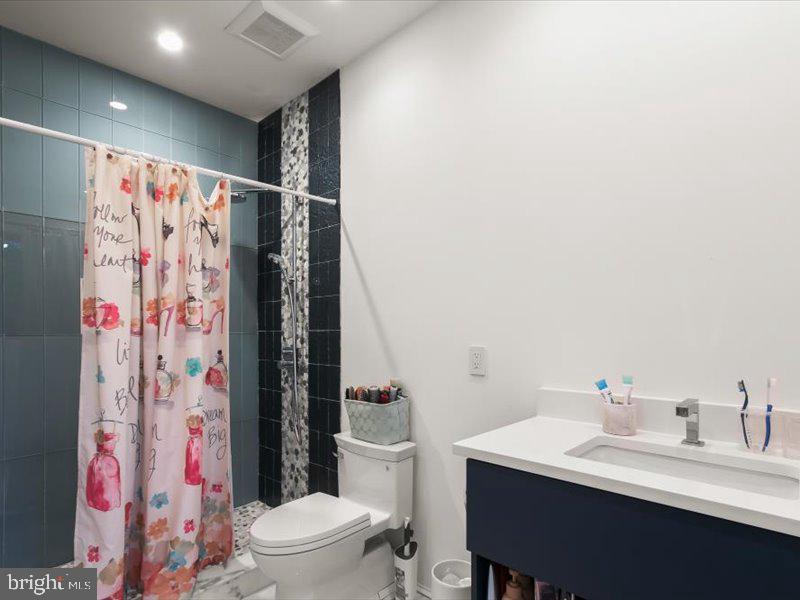 10130 Counselman Road Potomac, MD 20854 - Photo 30 of 135 a bathroom with a sink toilet and shower