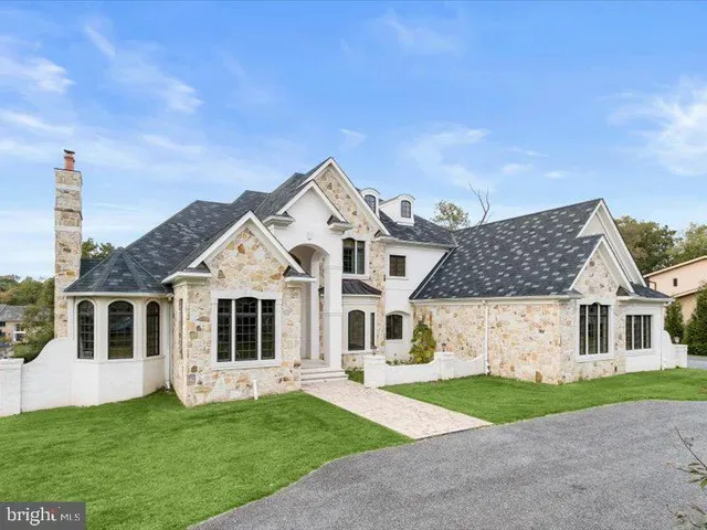 a front view of a house with a garden and yard