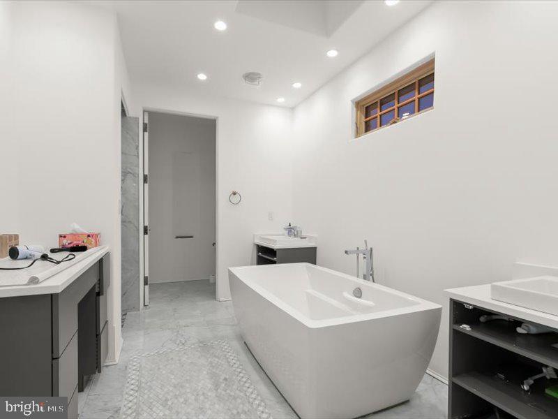 10130 Counselman Road Potomac, MD 20854 - Photo 43 of 135 a white bath tub sitting next to a bathroom sink