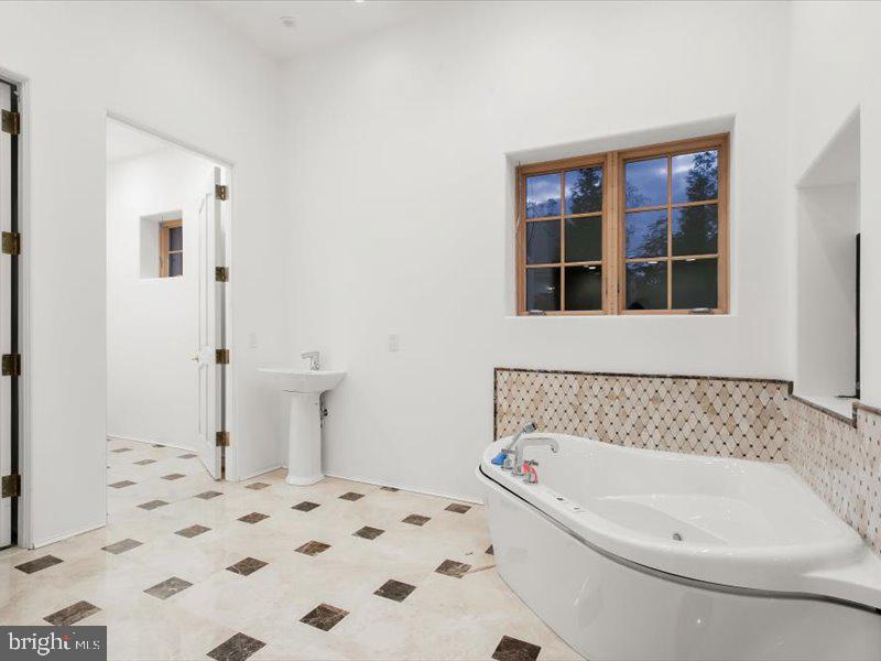 10130 Counselman Road Potomac, MD 20854 - Photo 56 of 135 a bathroom with a bathtub and a window