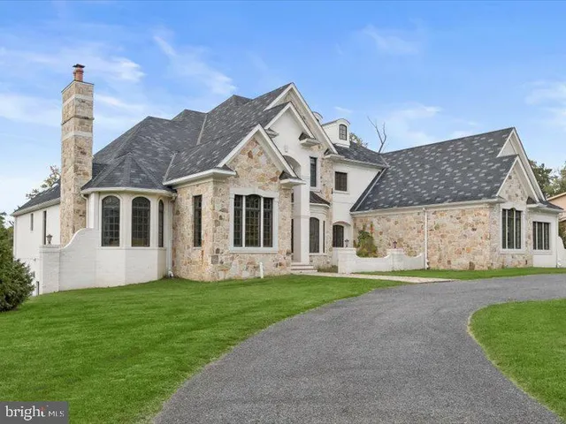 a front view of a house with garden and porch