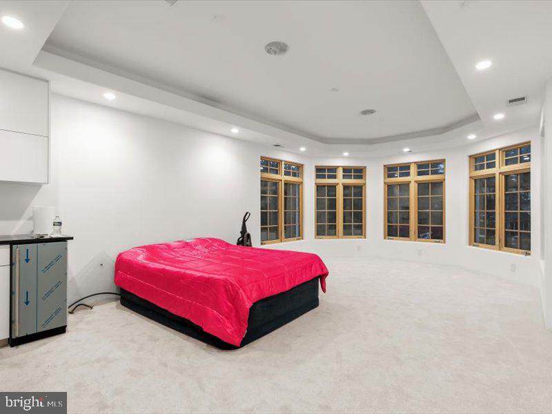 10130 Counselman Road Potomac, MD 20854 - Photo 90 of 135 a spacious bedroom with a bed and a large window