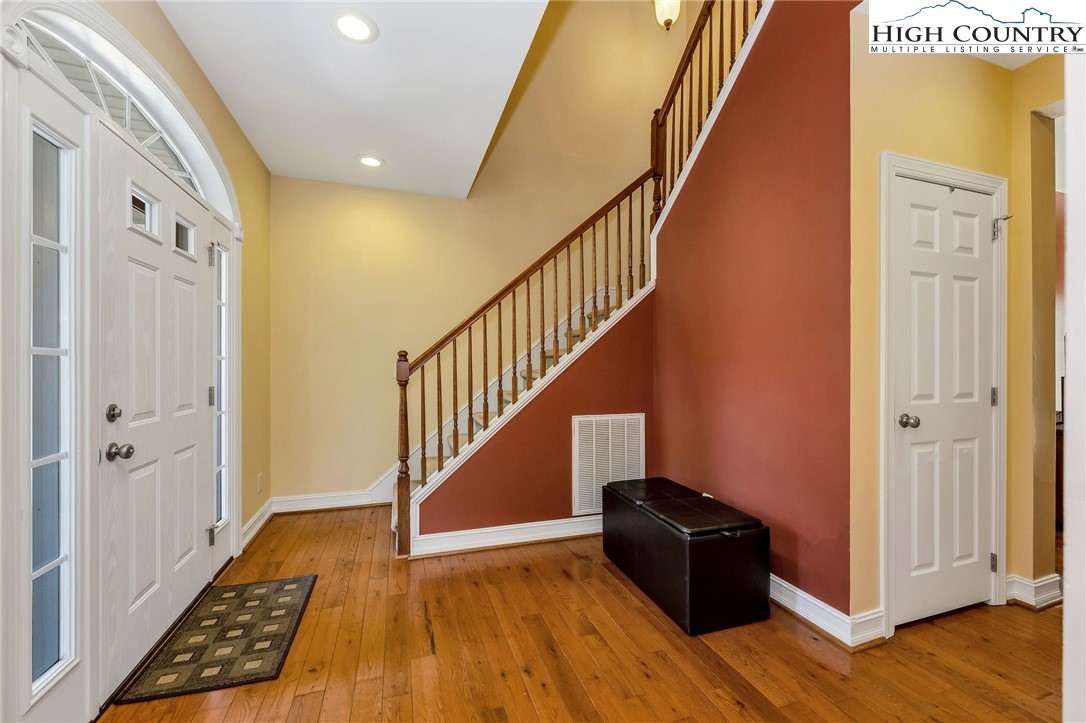 3186-3190 Silas Creek Road Lansing, NC 28643 - Photo 11 of 50 a view of a hallway with wooden floor and staircase