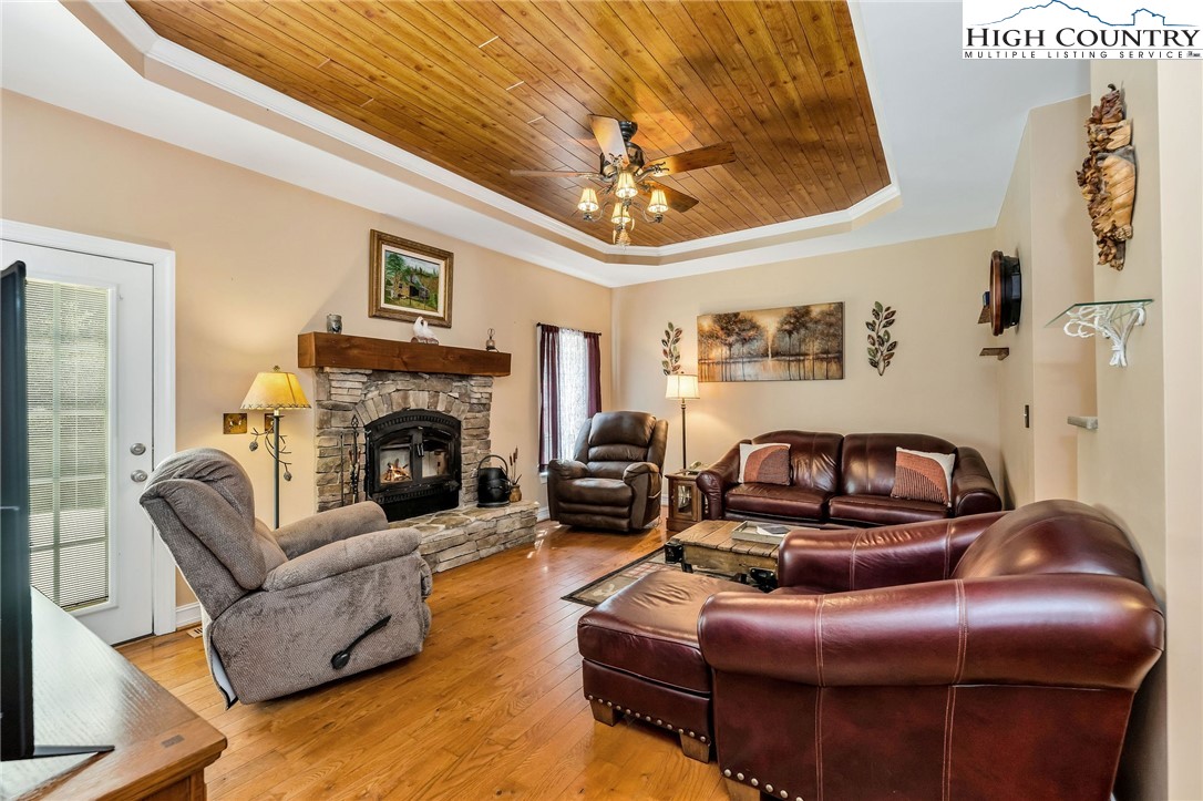 3186-3190 Silas Creek Road Lansing, NC 28643 - Photo 13 of 50 a living room with furniture a fireplace and a chandelier