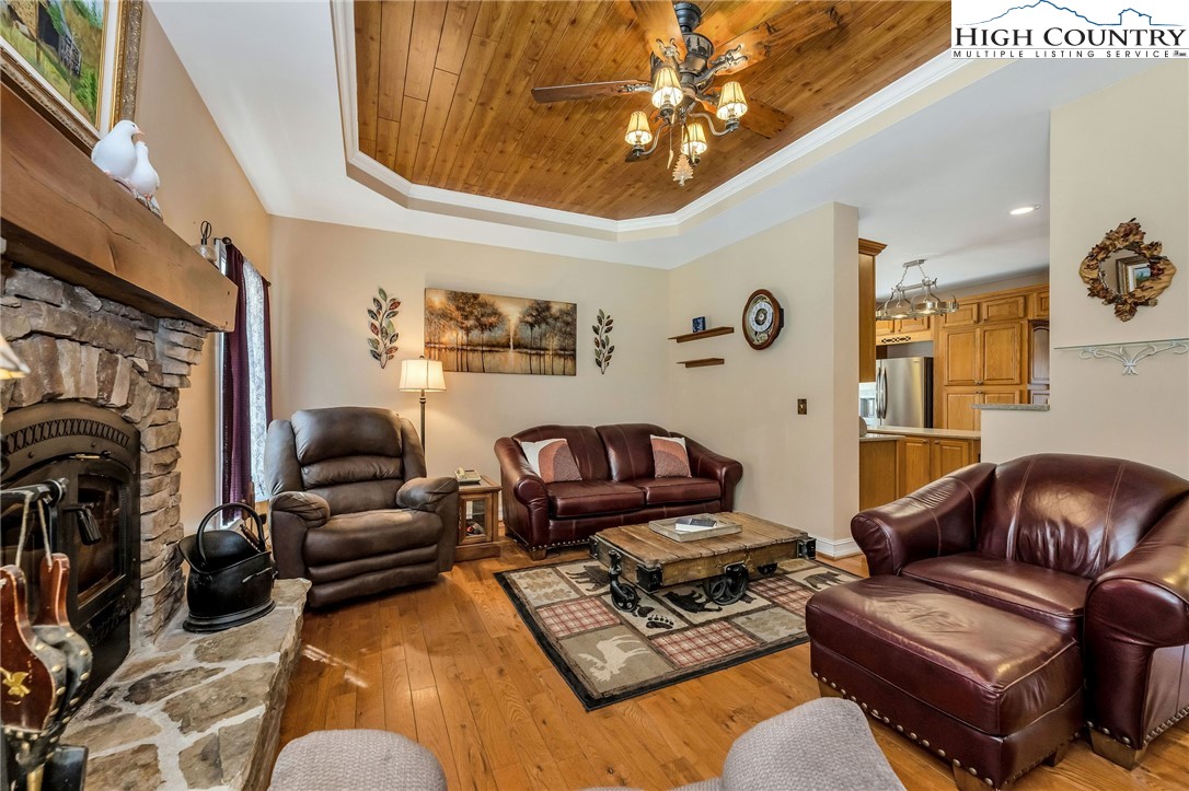 3186-3190 Silas Creek Road Lansing, NC 28643 - Photo 14 of 50 a living room with furniture a fireplace and a chandelier