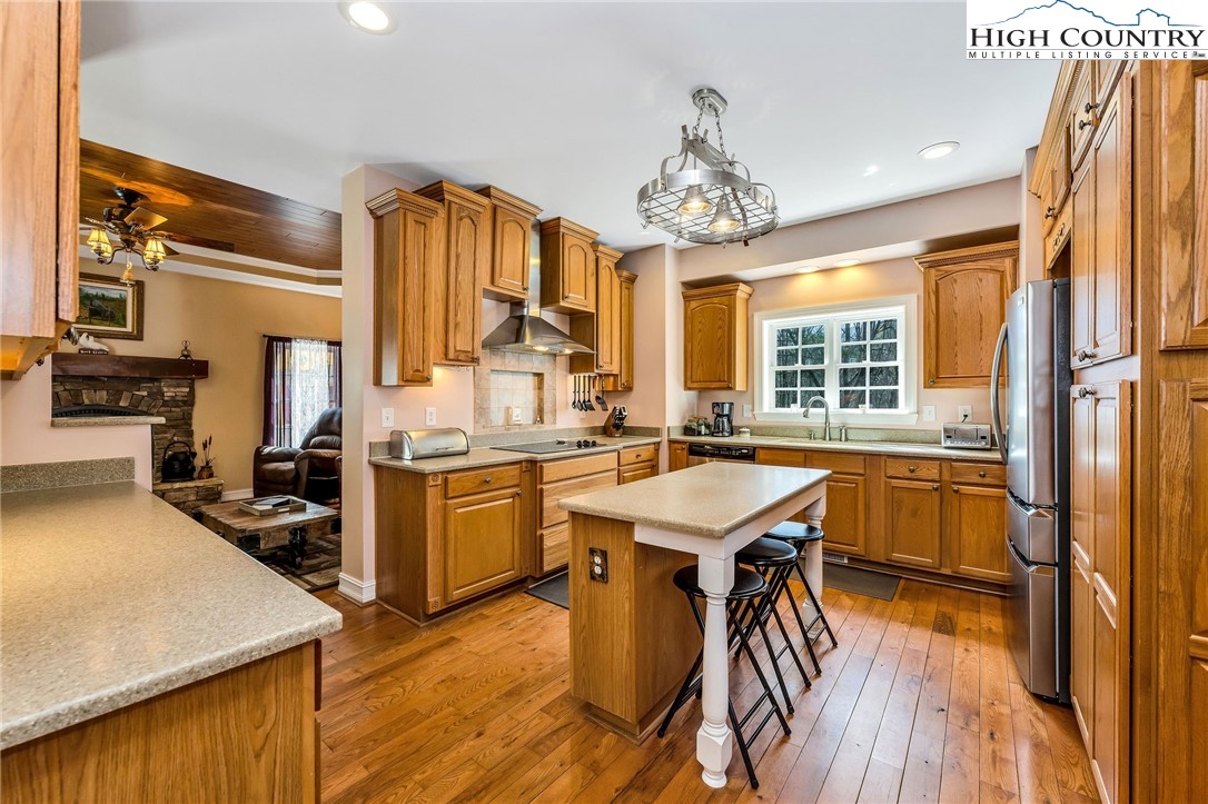 3186-3190 Silas Creek Road Lansing, NC 28643 - Photo 15 of 50 a kitchen with a table chairs stove and refrigerator