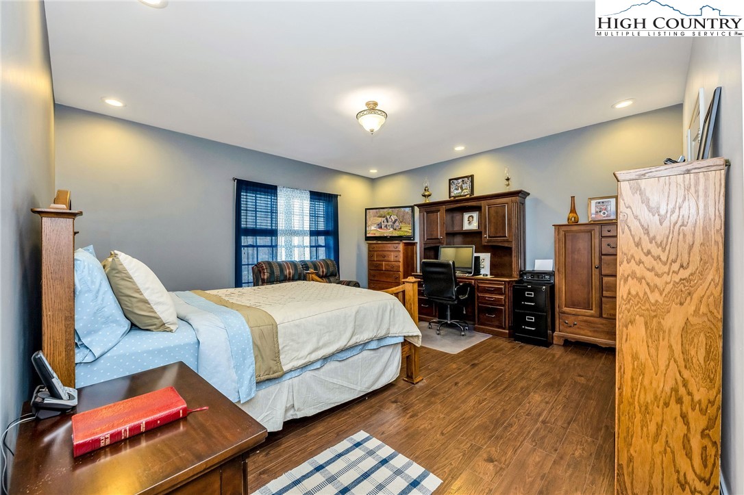 3186-3190 Silas Creek Road Lansing, NC 28643 - Photo 19 of 50 a bedroom with a bed furniture and a flat tv screen