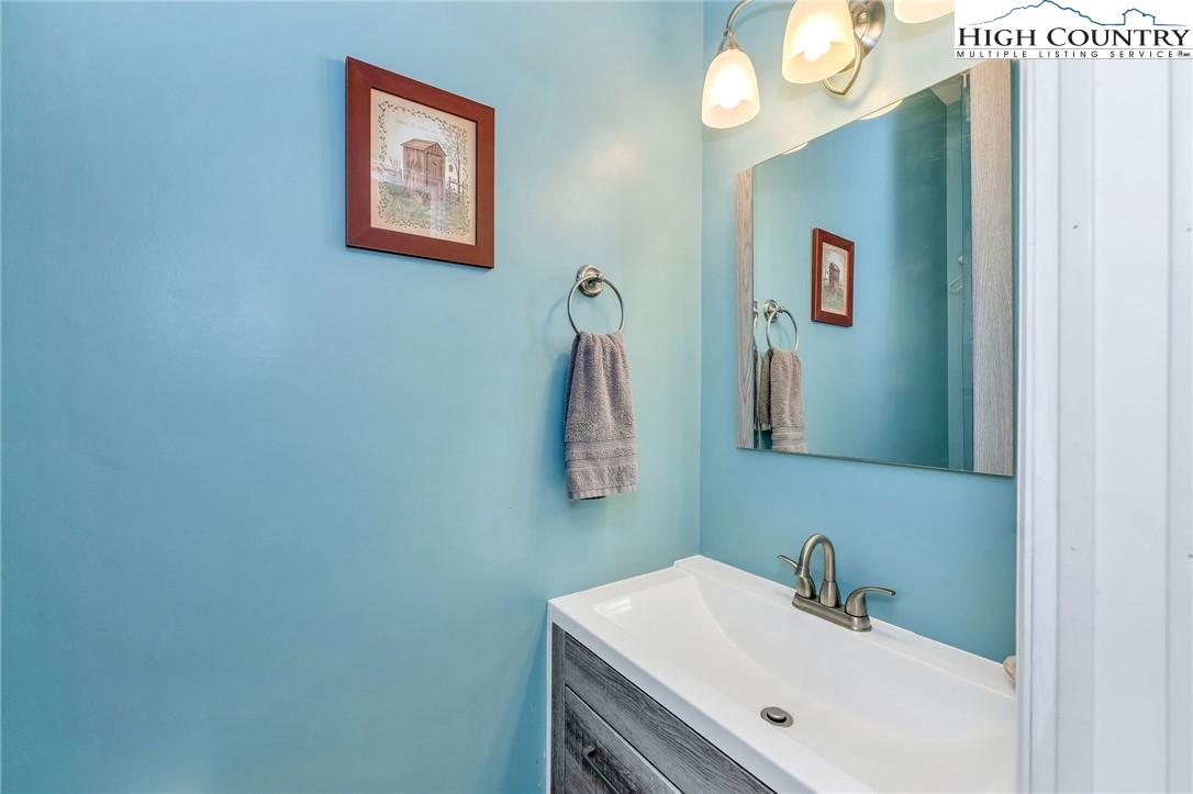 3186-3190 Silas Creek Road Lansing, NC 28643 - Photo 22 of 50 a bathroom with a sink and a mirror