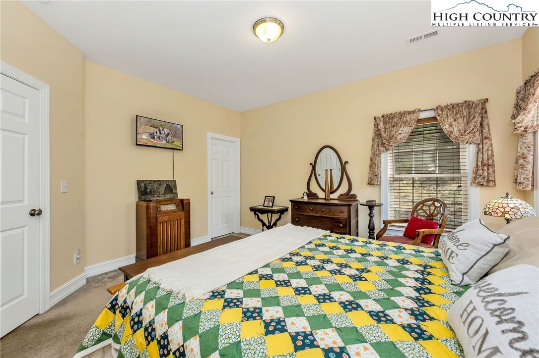 3186-3190 Silas Creek Road Lansing, NC 28643 - Photo 24 of 50 a bed sitting in a bedroom next to a window