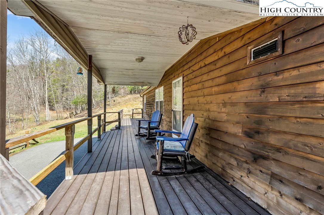3186-3190 Silas Creek Road Lansing, NC 28643 - Photo 34 of 50 a balcony with wooden floor and outdoor seating