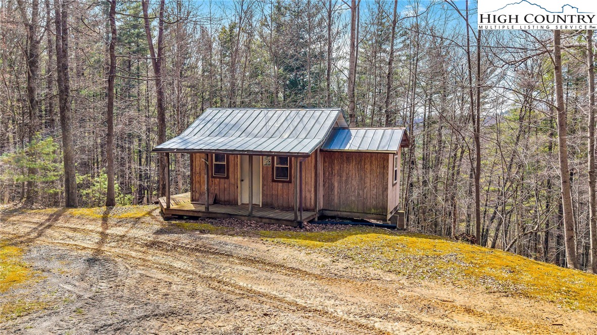 3186-3190 Silas Creek Road Lansing, NC 28643 - Photo 40 of 50 a front view of a house with a yard