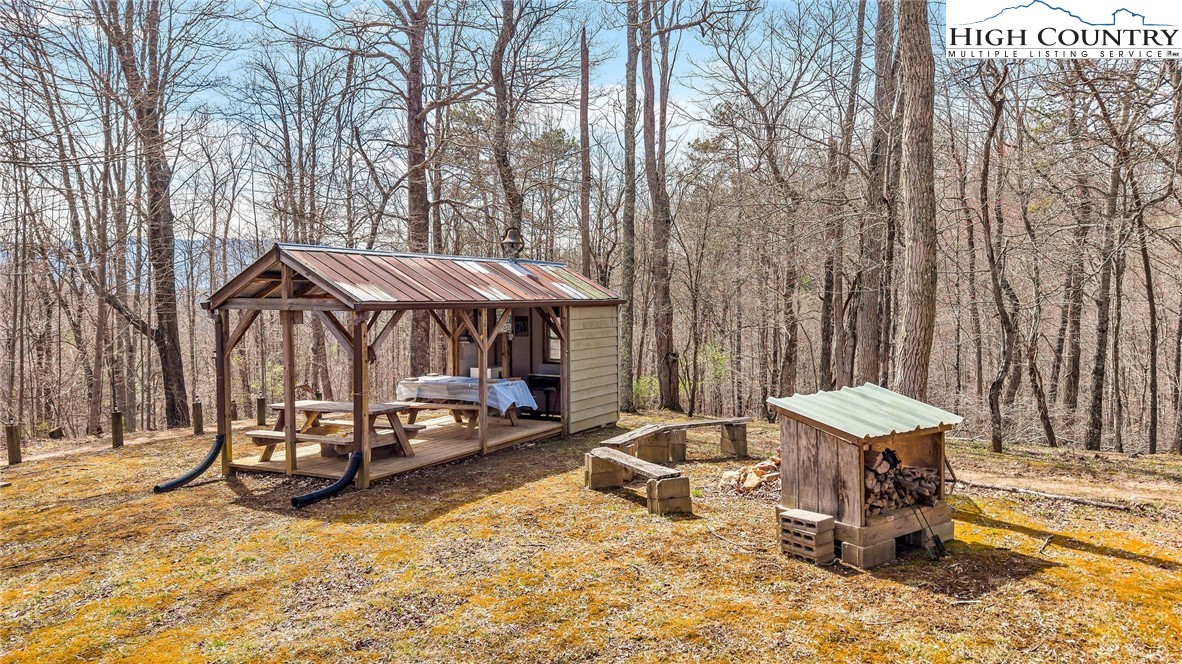 3186-3190 Silas Creek Road Lansing, NC 28643 - Photo 43 of 50 a view of a patio with a table and chairs under an umbrella