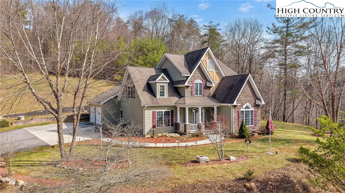 3186-3190 Silas Creek Road Lansing, NC 28643 - Photo 6 of 50 a front view of a house with swimming pool and porch