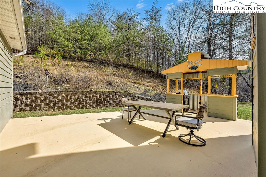 3186-3190 Silas Creek Road Lansing, NC 28643 - Photo 8 of 50 a view of a patio with a table and chairs