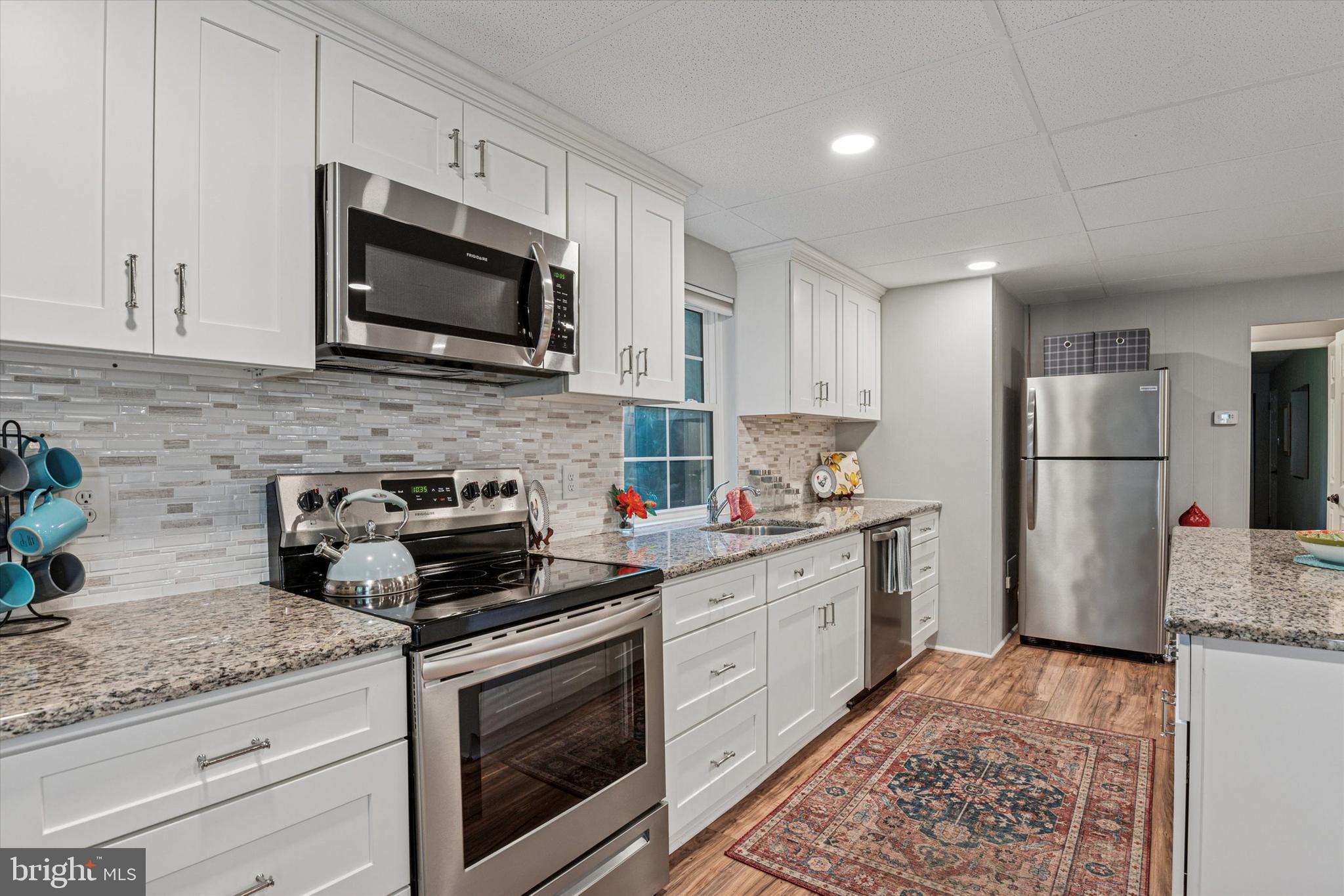 432 Spring Valley Road Media, PA 19063 - Photo 27 of 46 a kitchen with a stove microwave and refrigerator
