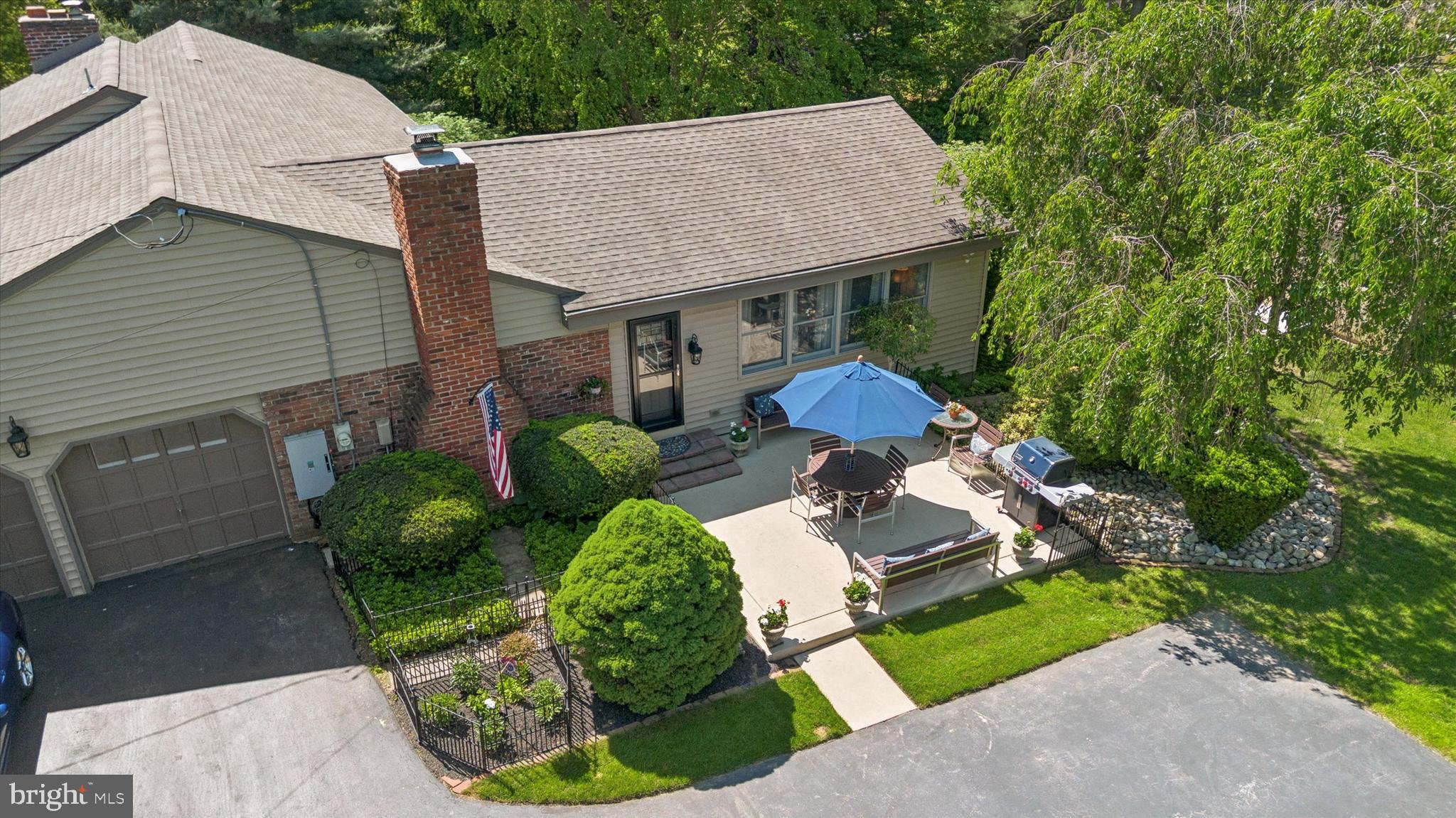 432 Spring Valley Road Media, PA 19063 - Photo 38 of 46 a aerial view of a house with table and chairs under an umbrella