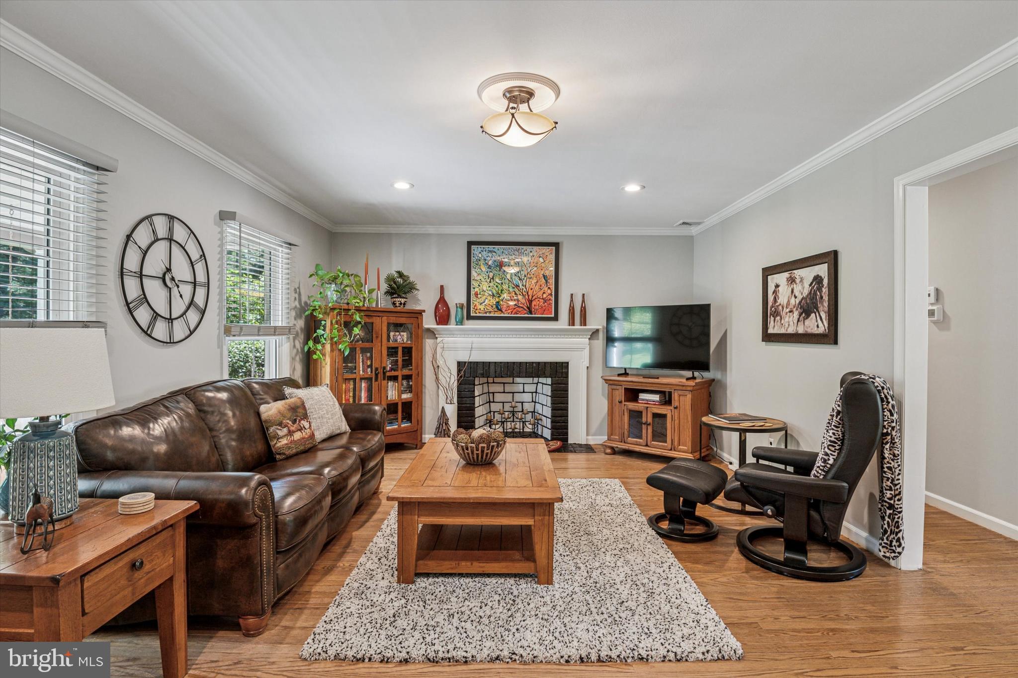 432 Spring Valley Road Media, PA 19063 - Photo 5 of 46 a living room with furniture a clock and a fireplace