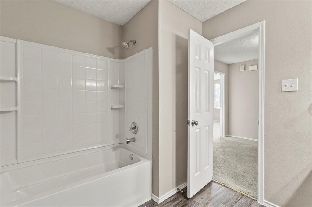 3004 Deer Ridge Drive Rockwall, TX 75032 - Photo 20 of 25 a bathroom with a bathtub and a shower