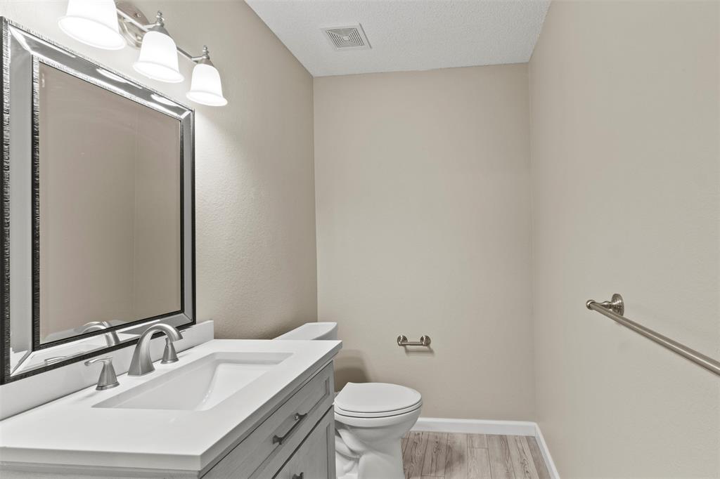 3004 Deer Ridge Drive Rockwall, TX 75032 - Photo 21 of 25 a bathroom with a sink vanity mirror and toilet