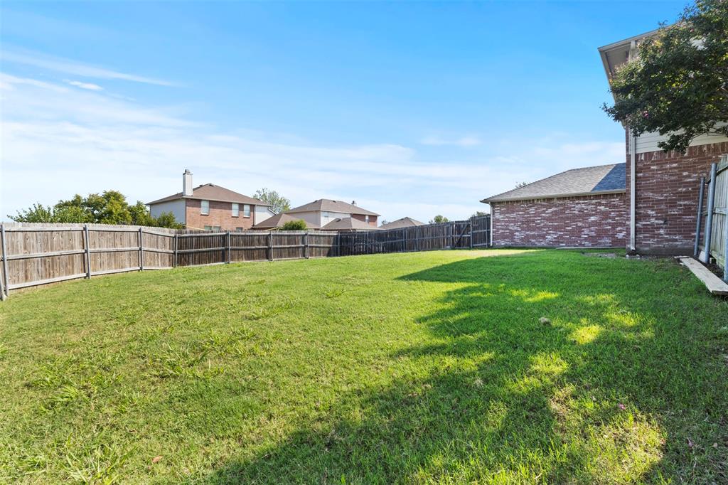 3004 Deer Ridge Drive Rockwall, TX 75032 - Photo 23 of 25 a view of a garden with a building in the background