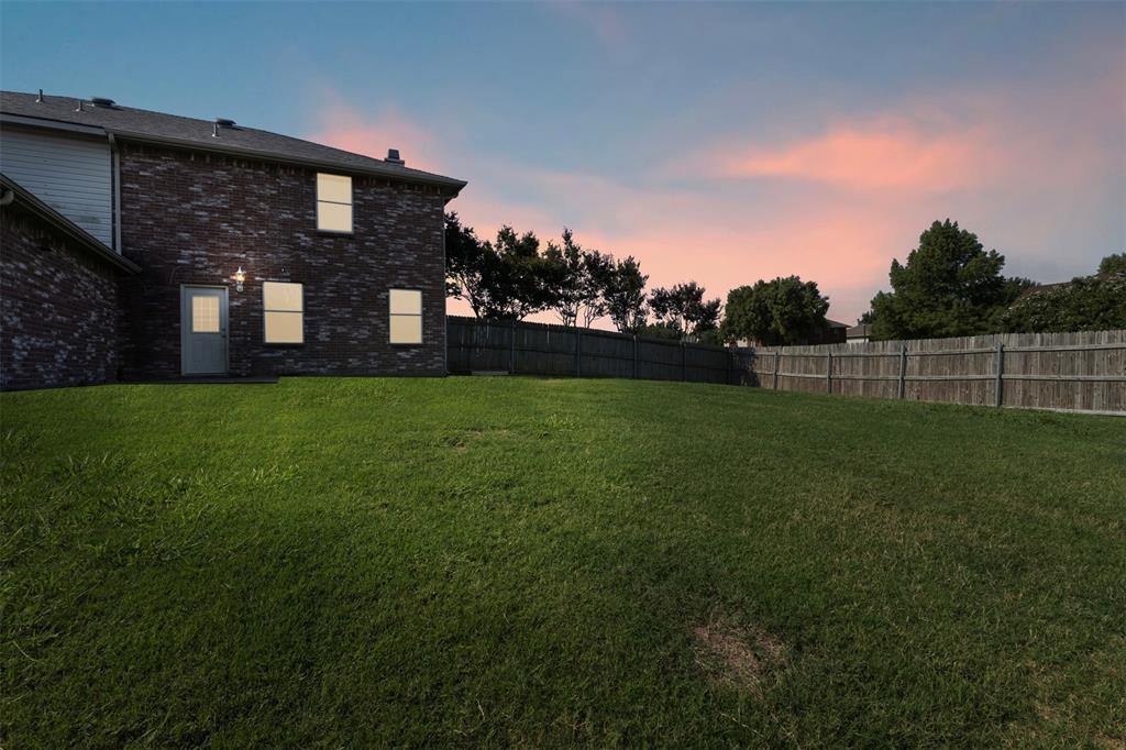 3004 Deer Ridge Drive Rockwall, TX 75032 - Photo 24 of 25 a brick house with a yard in front of it
