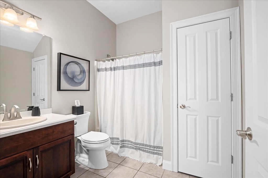 7 Primmett Lane, Unit 7 Worcester, MA 01609 - Photo 24 of 38 a bathroom with a toilet a sink and a mirror