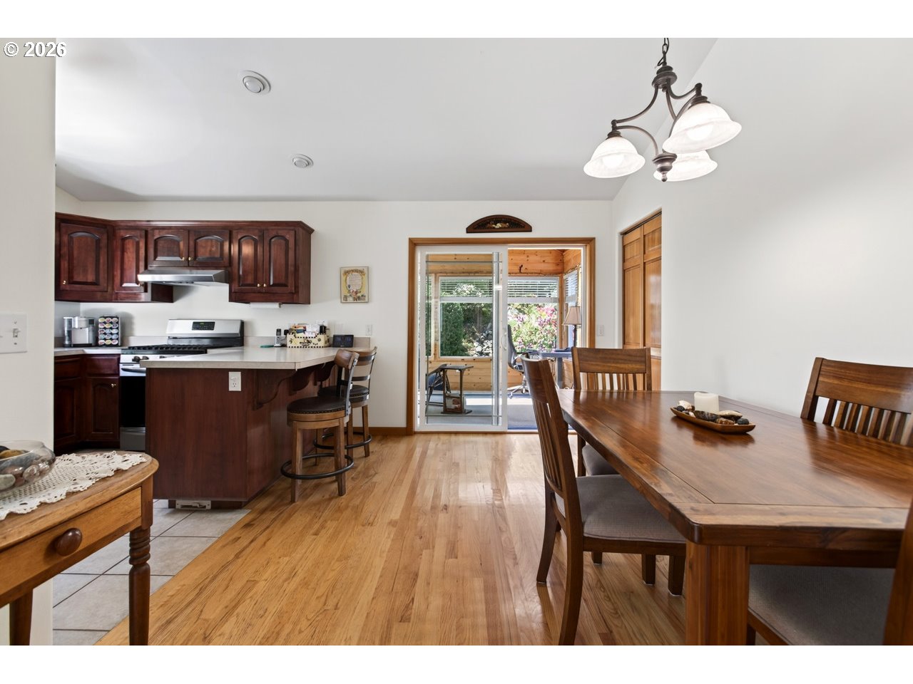 3956 Beach Loop Drive Southwest Bandon, OR 97411 - Photo 16 of 48 a dining room filled chandelier and wooden floor