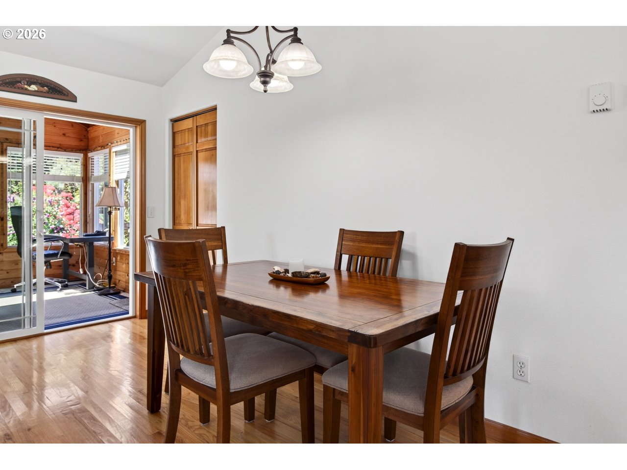 3956 Beach Loop Drive Southwest Bandon, OR 97411 - Photo 18 of 48 a view of a dining room with furniture wooden floor and a chandelier