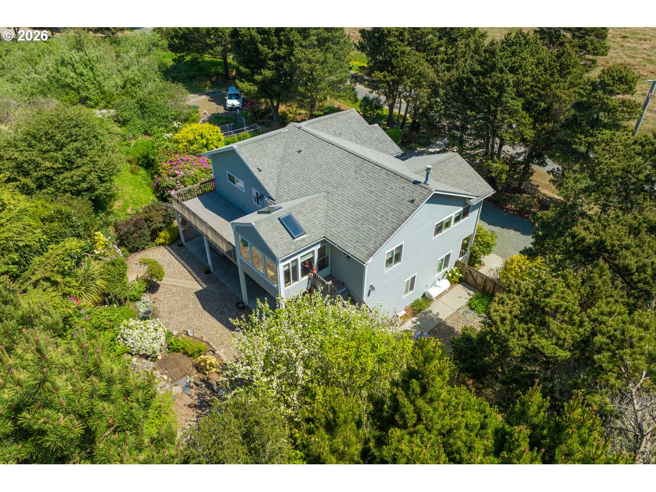 3956 Beach Loop Drive Southwest Bandon, OR 97411 - Photo 3 of 48 an aerial view of a house with a yard large trees and garage