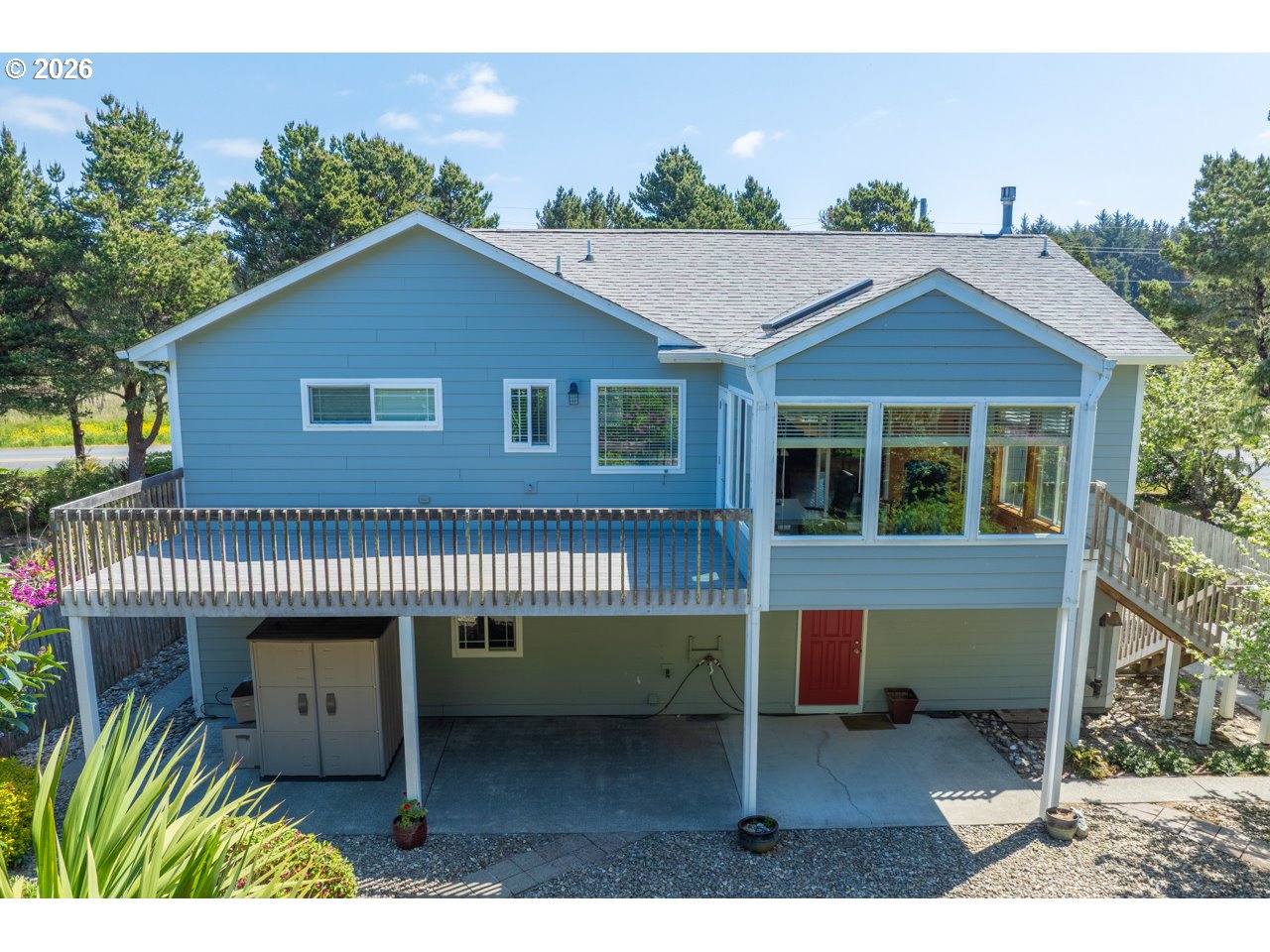 3956 Beach Loop Drive Southwest Bandon, OR 97411 - Photo 4 of 48 a front view of a house with a garden