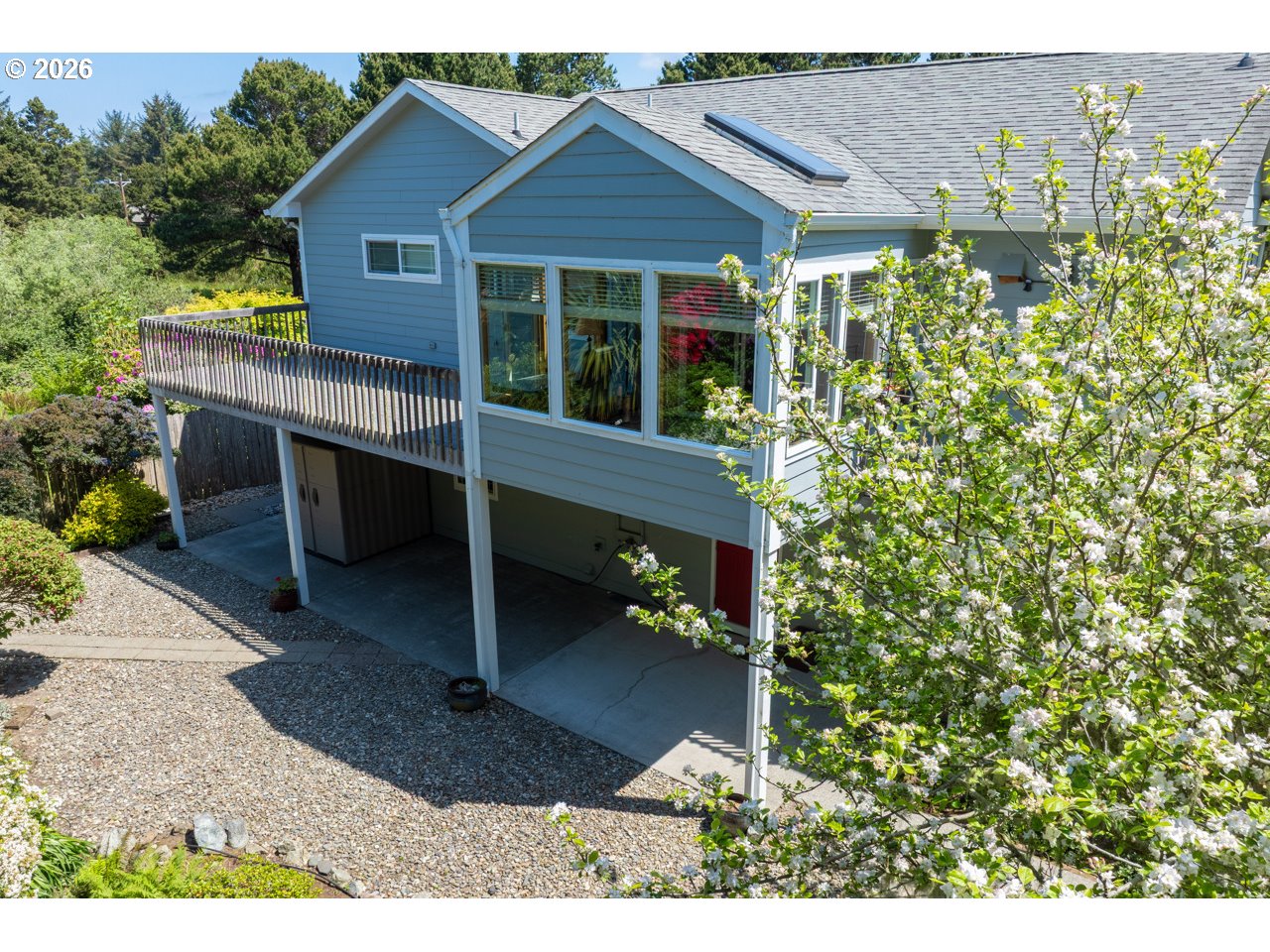 3956 Beach Loop Drive Southwest Bandon, OR 97411 - Photo 41 of 48 a view of a house with brick walls and a flower garden