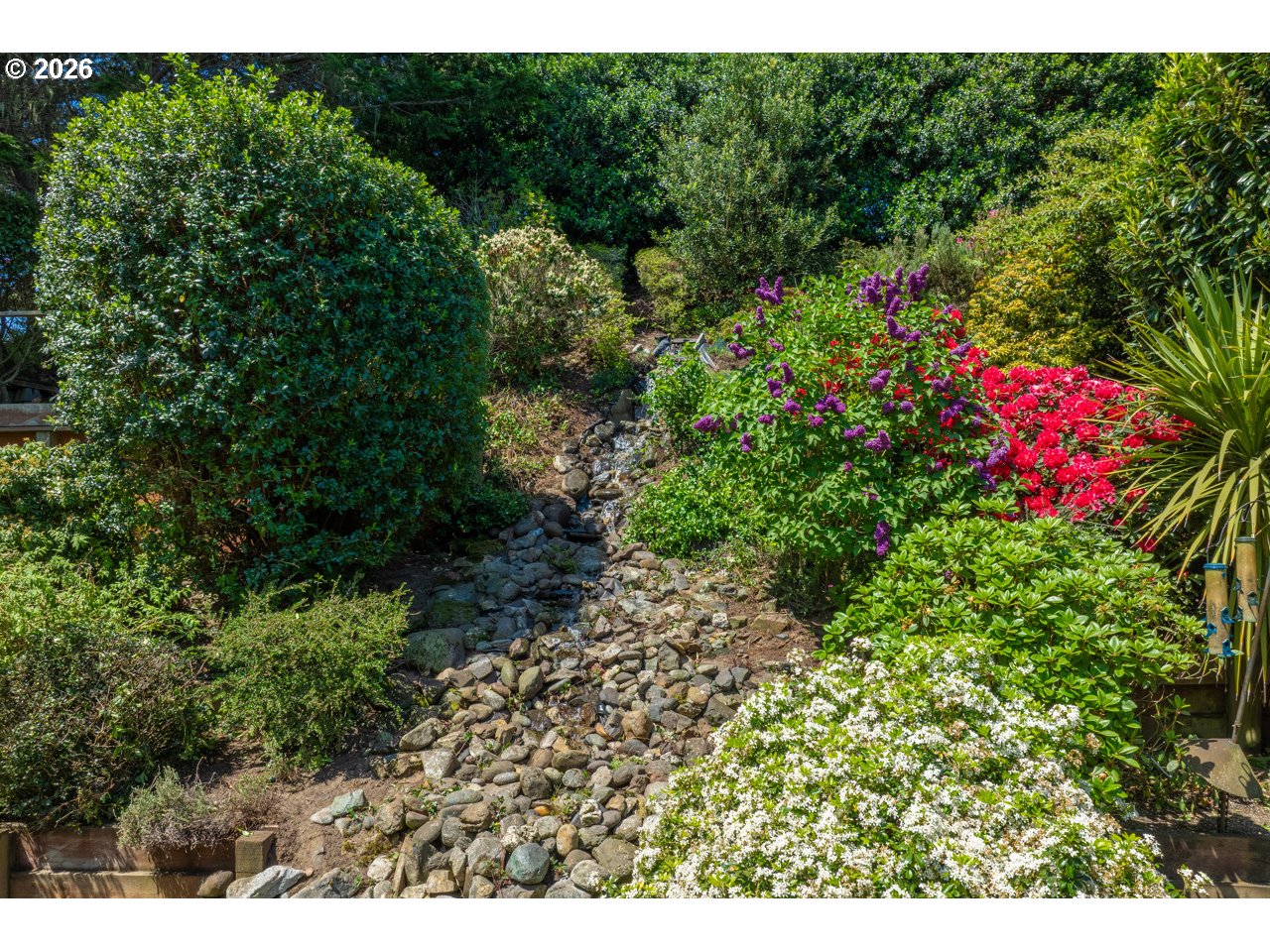 3956 Beach Loop Drive Southwest Bandon, OR 97411 - Photo 47 of 48 a view of a garden with flowers