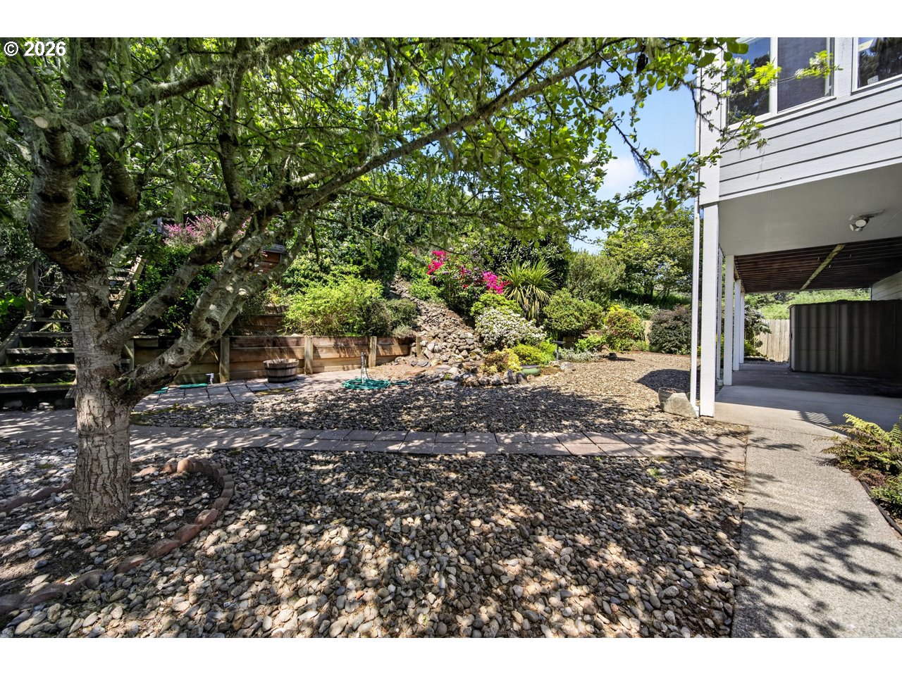 3956 Beach Loop Drive Southwest Bandon, OR 97411 - Photo 10 of 48 a view of a yard with plants and large tree