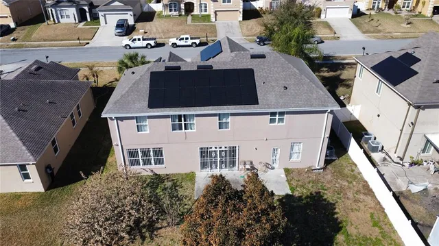 an aerial view of a house with a yard