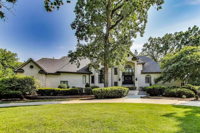a front view of houses with yard and green space