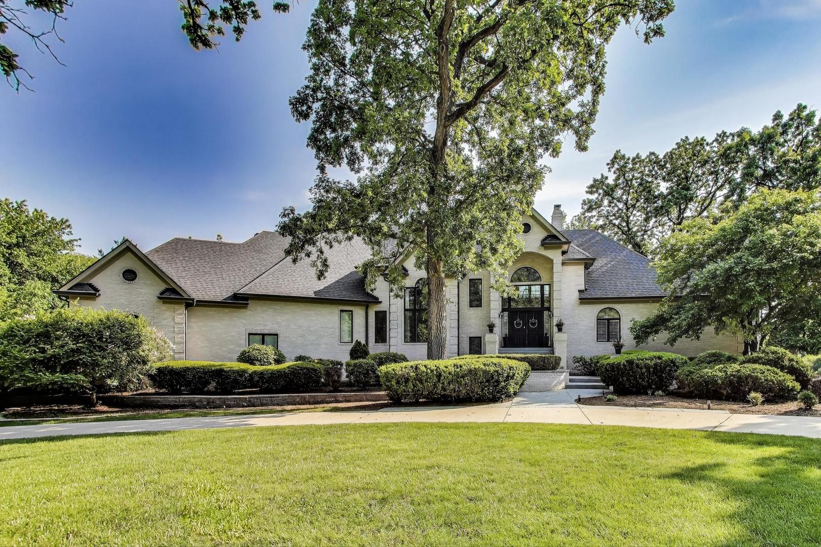 a front view of houses with yard and green space