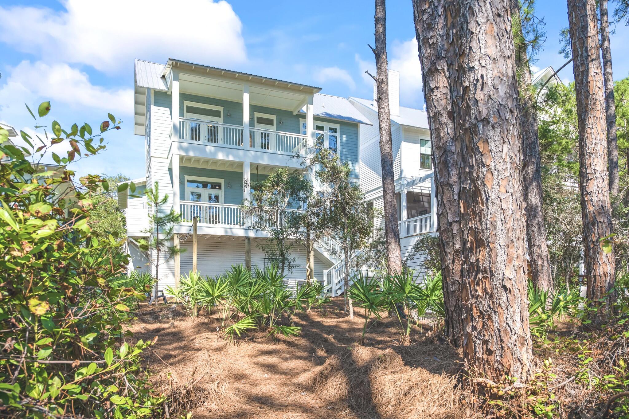391 Matt's Way Santa Rosa Beach, FL 32459 - Photo 2 of 61 a front view of a house with a garden