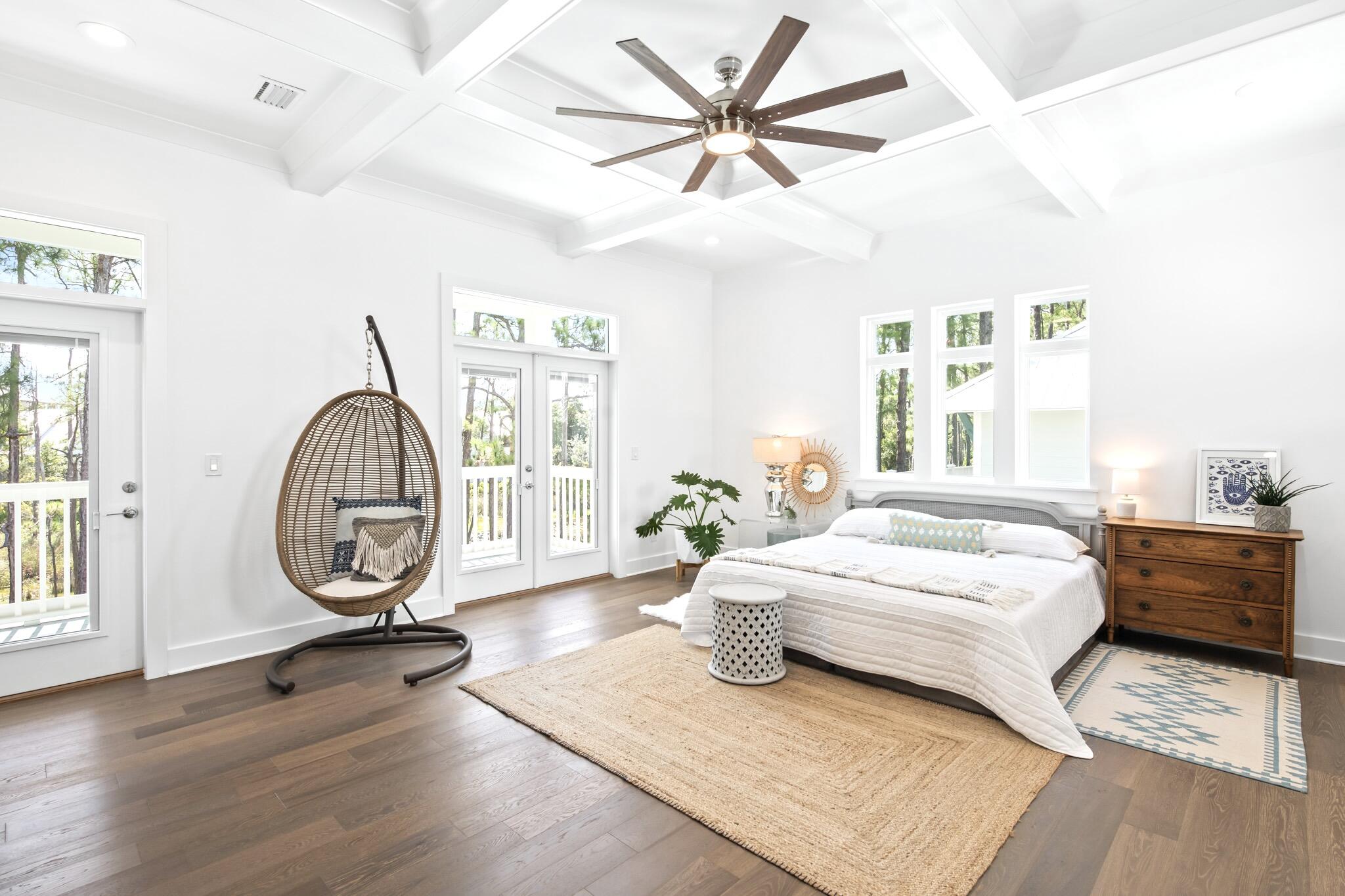 391 Matt's Way Santa Rosa Beach, FL 32459 - Photo 24 of 61 a spacious bedroom with a large bed a chandelier and windows