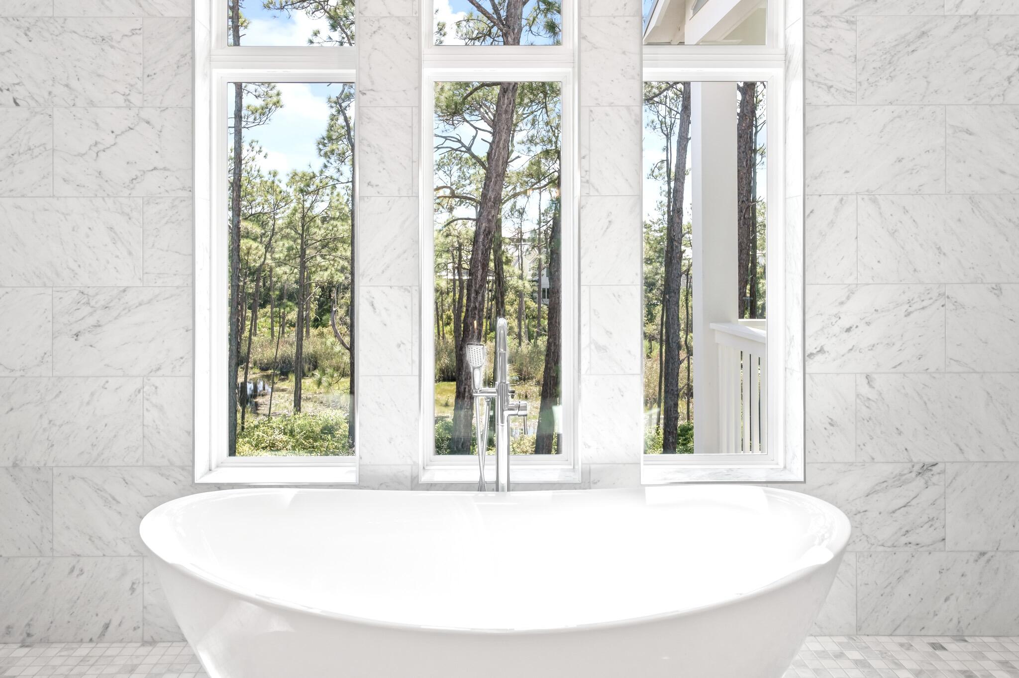 391 Matt's Way Santa Rosa Beach, FL 32459 - Photo 30 of 61 a white bath tub sitting in a bathroom next to a window