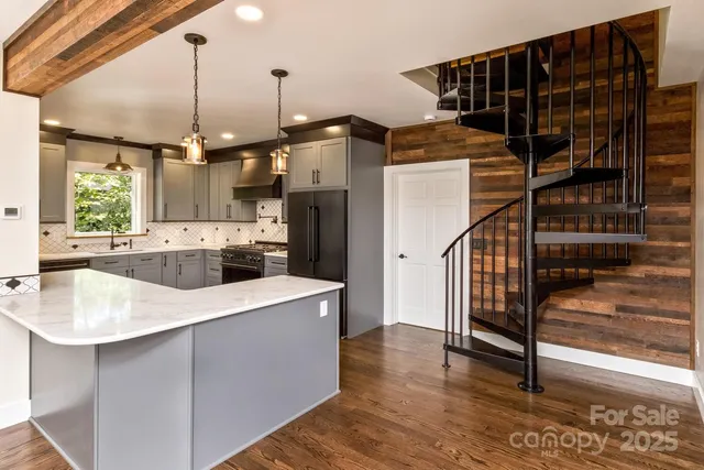 a kitchen with kitchen island a sink a stove and a refrigerator