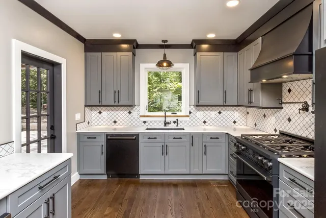 a kitchen with a sink stove top oven and cabinets