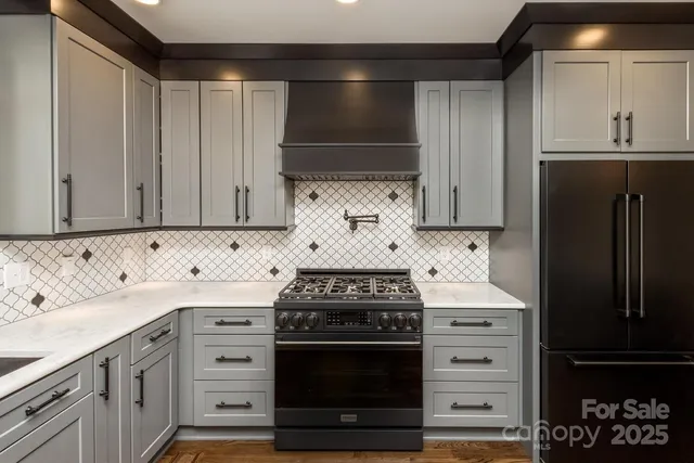 a kitchen with granite countertop a stove and a refrigerator