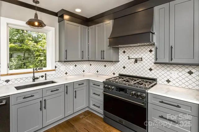 a kitchen with cabinets appliances and a window