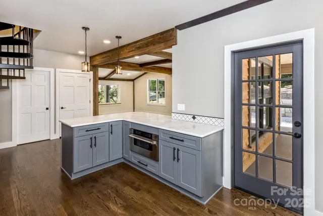a kitchen with a stove and a wooden floors