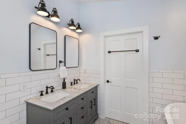 a bathroom with a double vanity sink mirror and vanity