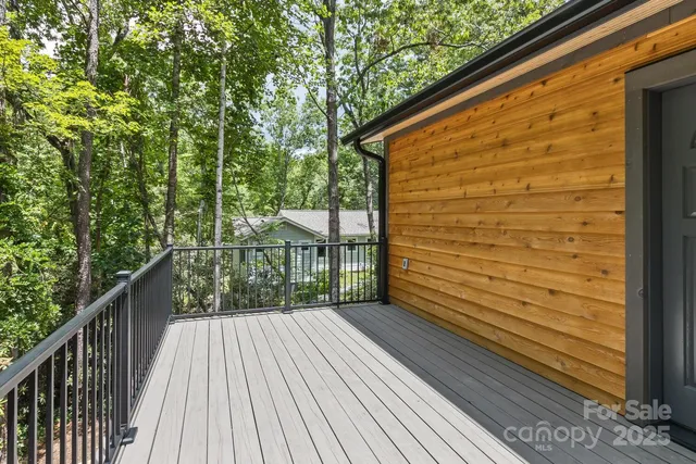a view of a balcony with wooden floor and fence